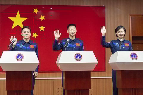 Chinese astronauts from left Cai Xuzhe, Chen Dong and Liu Yang, right, wave as they attend a press conference for the upcoming Shenzhou-14 mission(Photo | AP)