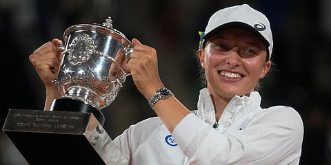 Iga Swiatek holds the trophy after winning the final against Coco Gauff in two sets, 6-1, 6-3, at the French Open tennis tournament in Roland Garros Stadium in Paris, France. (Photo | AP)