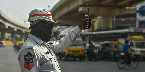 A traffic police officer covers his ears and face with cloth as he discharges his duties under scorching sun at Benz Circle in Vijayawada. (File photo| Prasant Madugala, EPS)