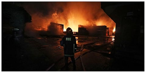 A firefighter works to contain a fire that broke out at the BM Inland Container Depot, a Dutch-Bangladesh joint venture, in Chittagong on Sunday, June 5, 2022 (Photo | PTI)