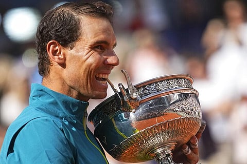 Spain's Rafael Nadal bites the trophy after winning the final match against Norway's Casper Ruud in three sets, 6-3, 6-3, 6-0, at the French Open tennis tournament(Photo | AP)