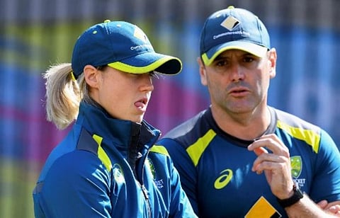 Australia's Ellyse Perry (L) watches her teammates train in the nets with bowling coach Ben Sawyer (R). (Photo | AFP)