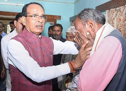 Uttarakhand CM Pushkar Singh Dhami with Madhya Pradesh CM Shivraj Singh Chouhan meet relatives of victims of a bus accident in Damta area of Uttarkashi. (Photo | PTI)