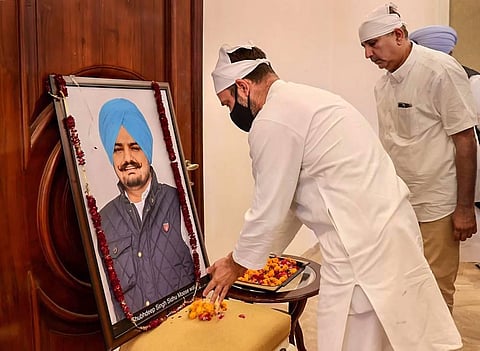 Congress leader Rahul Gandhi pays tribute during his visit to family of late singer and Congress leader Sidhu Moose Wala. (Photo | PTI)