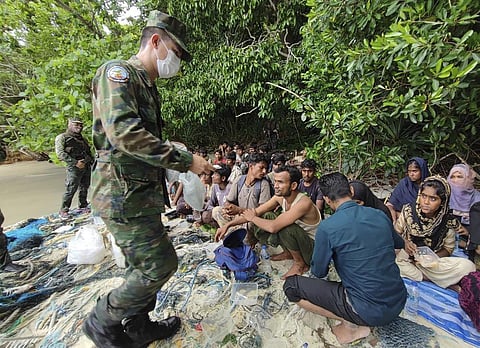 Members of the Thai navy help Rohingya refugees found on Koh Dong Island in Satun province, southern Thailand. (Photo | AP)