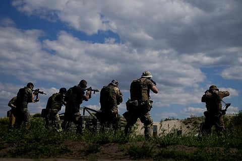 Civilian militia men hold rifles during training at a shooting range in outskirts Kyiv, Ukraine. (Photo | AP)