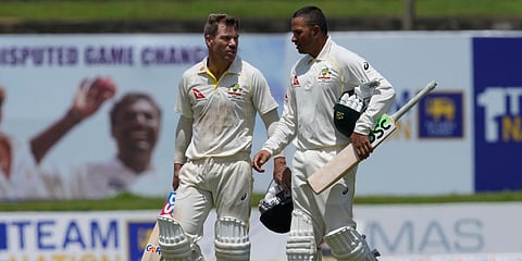 Australia's David Warner(L) and Usman Khawaja walk back to pavilion after defeating Sri Lanka by ten wickets win in Day 3 of the 1st Test match in Galle, Sri Lanka. (Photo| AP)