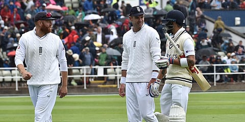 India's Virat Kohli (R) leaves the field with England's James Anderson (C) and Jonny Bairstow after rain stopped play during the Day 1 of the 5th Test match at Edgbaston. (Photo| AP)