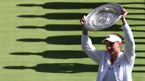 Elena Rybakina celebrates with the Venus Rosewater Dish trophy after winning the women's singles final tennis. (Photo | AFP)
