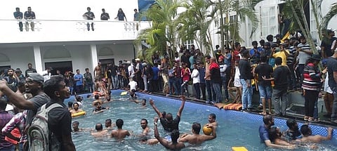 Anti government protesters swim in a swimmingpool of the Sri lankan president's official residence after storming into it in Colombo, Sri Lanka.