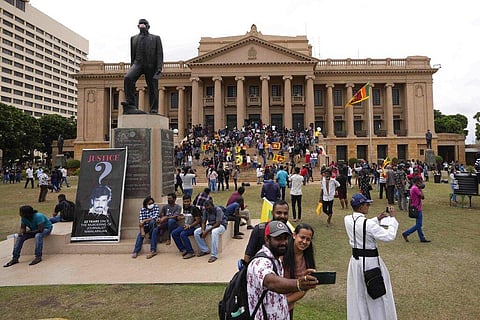 Protesters walk around and spend time at the ongoing protest site a day after storming into president's office in Colombo, Sri Lanka, Sunday, July 10, 2022. (Photo | AP)
