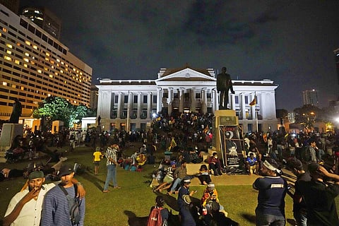 Protesters sit and walk around after storming in at the Sri Lankan president's office, in Colombo, Sri Lanka , Saturday, July, 9, 2022. (Photo | AP)