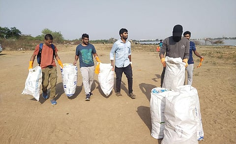 Vinay and his friends clear out garbage from Ameenpur lake in Sangareddy district.