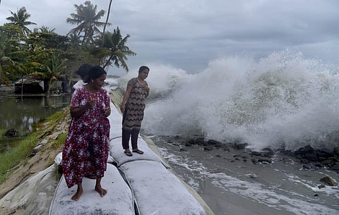 Residents of Kannamaly try to evade the high waves. (Photo | A Sanesh, EPS)