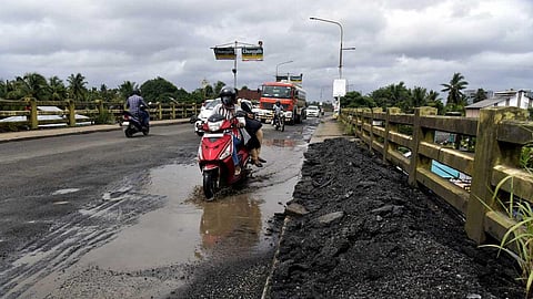Vehicles pass through the pothole-filled Thevara-Kundannoor bridge.