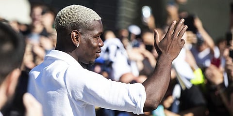 Midfielder Paul Pogba waves to fans as he arrives at Juve's Medical Center, in Turin, northern Italy, Saturday, July 9, 2022.(Photo | AP)