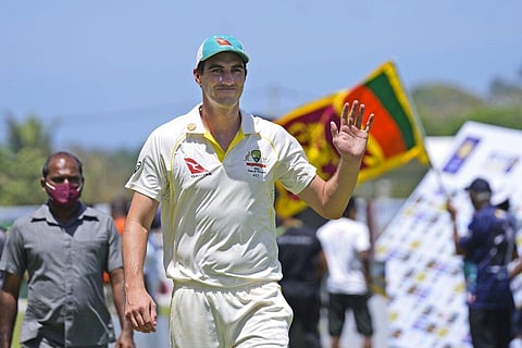 Australia's cricket captain Pat Cummins waves to fans after defeating Sri Lanka by ten wickets win in day three of the first test cricket match. (Photo | AP)