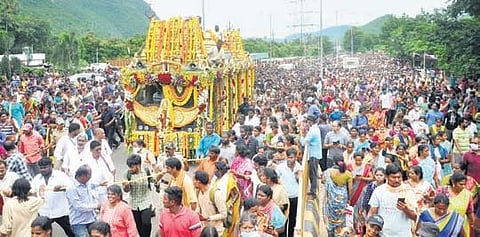 Devotees walk along with the chariot of Sri Varaha Lakshmi Narasimha Swamy at Simhachalam for Giri Pradakshina in Visakhapatnam. (Photo| G Satyanarayana, EPS)