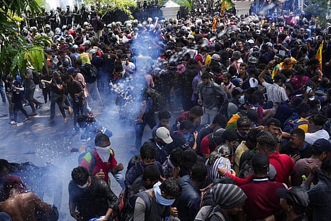 Police use teargas as Sri Lankan protesters storm the compound of prime minister Ranil Wickremesinghe 's office, demanding he resign. (Photo | AP)