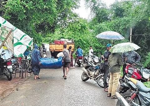 Villagers shift their belongings to safer places as floodwater enters Gandi Posamma village of Devipatnam mandal on Wednesday | Express