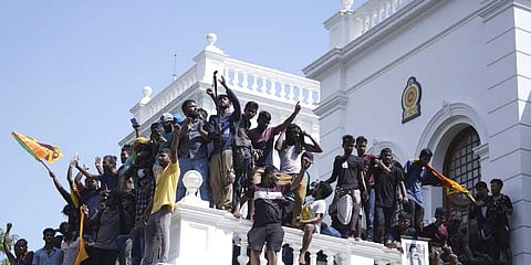 Sri Lankan protesters after storming the Prime Minister's office, demanding he resign after Gotabaya Rajapaksa fled the country in Colombo, Sri Lanka, Wednesday, July 13, 2022. (PTI)