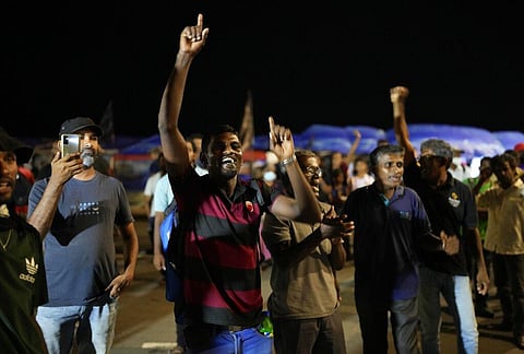 Sri Lankans celebrate as they react to early reports of President Gotabaya Rajapaksa's resignation in Colombo. (Photo | AP)