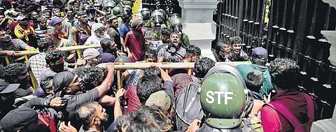 Protesters use an iron barricade to break open the gate of Sri Lankan Prime Minister Ranil Wickremesinghe’s office before storming it, in Colombo on Wednesday (Photo| AP)