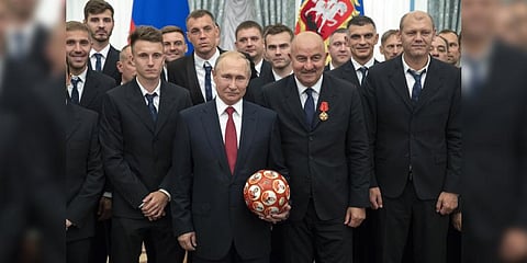 Vladimir Putin, center left, and Russia's soccer team head coach Stanislav Cherchesov, center right.(File Photo | AP)