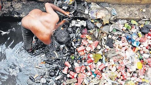 A private contract worker cleaning a drain in Tirupati. (Photo| Madhav K, EPS)