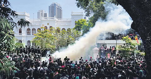 Police use teargas as Sri Lankan protesters storm the compound of Prime Minister's office. (Photo | PTI)