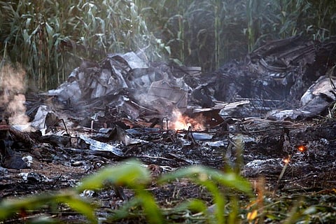 A flame is seen amid debris of an Antonov cargo plane in Palaiochori village in northern Greece, July 17, 2022, after it reportedly crashed near the city of Kavala. (Photo | AP)