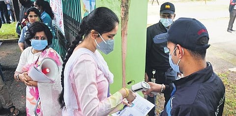 A candidate undergoes thermal screening before entering a NEET UG examination centre in Bengaluru on Sunday | Shriram BN