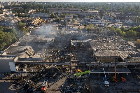Ukrainian State Emergency Service firefighters work to take away debris at a shopping center burned after a rocket attack in Kremenchuk, Ukraine, June 28, 2022. (File Photo | AP)