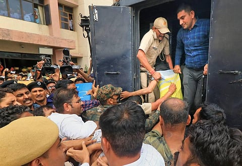 An accused in Kanhaiya Lal killing case being taken back to custody after he was produced at an NIA court, in Jaipur, Saturday, July 2, 2022. (Photo | PTI)
