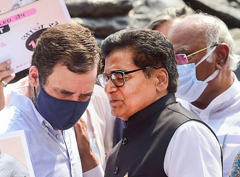Congress MP Rahul Gandhi listens to Samajwadi Party MP Ramgopal Yadav during a protest against inflation and the decision to increase GST on food items. (Photo | PTI)