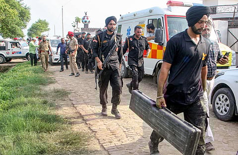 Punjab policemen at the site of an encounter in which two gangsters, suspected to be involved in the killing of singer Sidhu Moosewala, were killed, in Amritsar, on July 20, 2022. (PTI Photo)