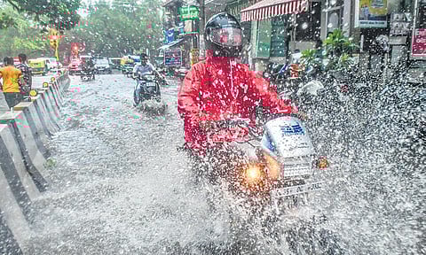 Commuters wade through a waterlogged road following incessant monsoon rains on Wednesday | pti