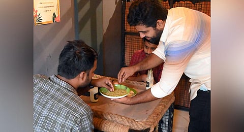 Dr Subasish, one among the two founders of Hemp Station in Kozhikode, introducing the hemp seed to customers. (Photo | E Gokul, EPS)