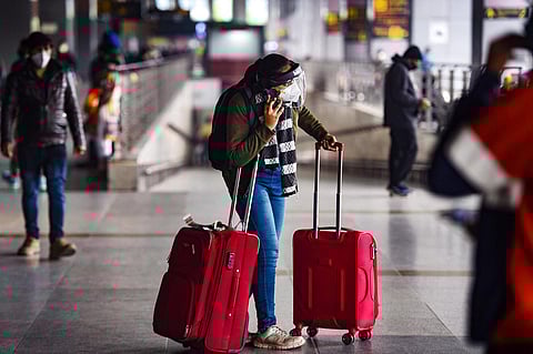 Air passengers wait outside Indira Gandhi International Airport, in New Delhi. (Photo | PTI)