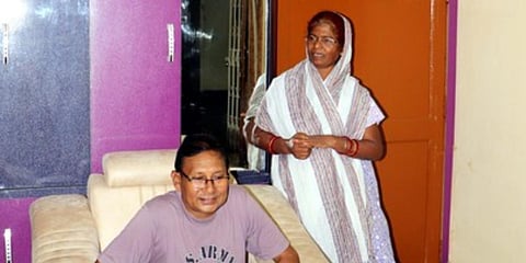Droupadi Murmu's younger brother Taranisen with his wife at her house in Rairangpur. (Photo| Irfana, EPS)
