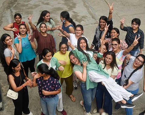 Students celebrate their success after announcement of CBSE Class 12th exam results, at St. Thomas' Girls Senior Secondary School, in New Delhi. (Photo | PTI)