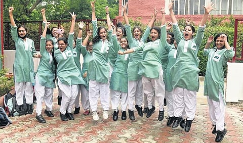 Students celebrate their success after announcement of the CBSE exam results at St. Thomas Girls Senior Secondary School in New Delhi on Friday | Parveen Negi