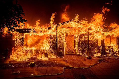 Flames engulf a chair inside a burning home as the Oak Fire burns in Mariposa County, California, on July 23, 2022. (Photo | AP)