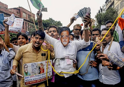 Congress workers protest against West Bengal Minister Partha Chatterjee with fake currencies after he was arrested by ED officials. (Photo | PTI)