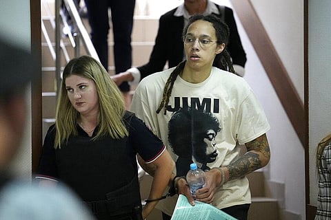 WNBA star and two-time Olympic gold medalist Brittney Griner is escorted to a courtroom for a hearing, in Khimki just outside Moscow, Russia. (File Photo | AP)