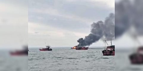 Video grab of smoke billowing out of a vessel in flames mid-sea | Express