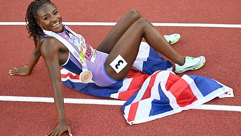 Dina Asher-Smith celebrates after winning bronze at the 2022 world championships in Eugene, Oregon.(AFP/File)