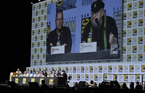 The cast and crew of 'House of the Dragon' attend a panel on day three of Comic-Con International. . Seen on screen are Ryan J. Condal, left, and George R. R. Martin. (Photo | AP)