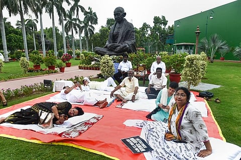AAP MP Sanjay Singh with TMC MP Dola Sen and other MPs, suspended from the Rajya Sabha, during their protest at Parliament House complex during ongoing Monsoon Session, in New Delhi. (Photo | PTI)
