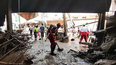 Members of a rescue team work at the scene of a flash flood in the northwestern part of Tehran, Iran. (Photo | AP)